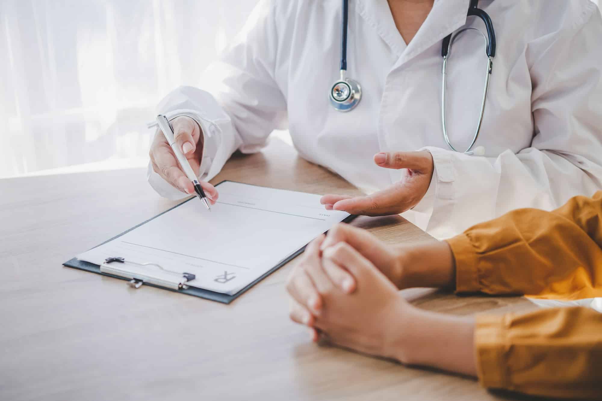 Close-up of the psychiatrist's hand holding the patient's hand. To encourage and comfort the patient